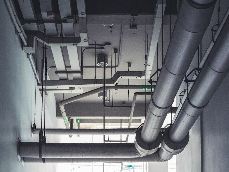 a room with a lot of pipes hanging from the ceiling